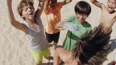 Close-up-shot-of-happy-boy-pouring-water-on-friends-head